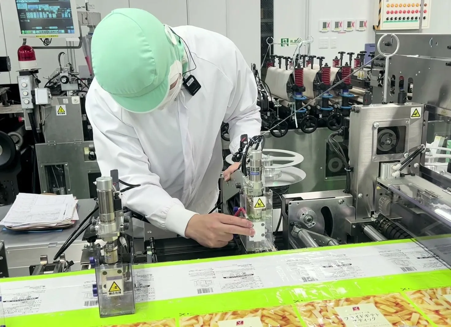製袋機の部品を調整する製造スタッフ